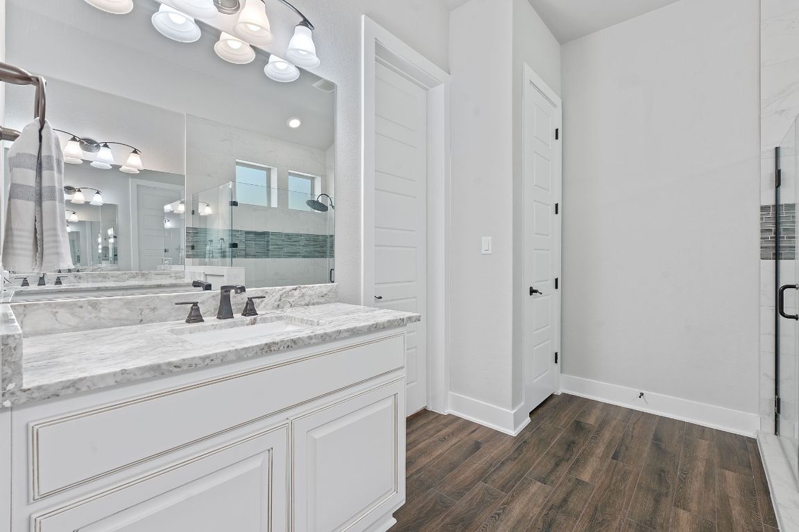 159 Raptor Beak Way Cedar Creek, TX 78612 - Photo 16 of 31 a bathroom with a sink and a mirror