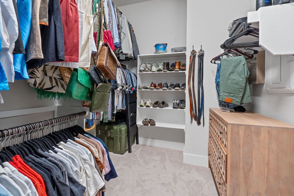 159 Raptor Beak Way Cedar Creek, TX 78612 - Photo 19 of 31 a view of walk in closet with clothes and shoes