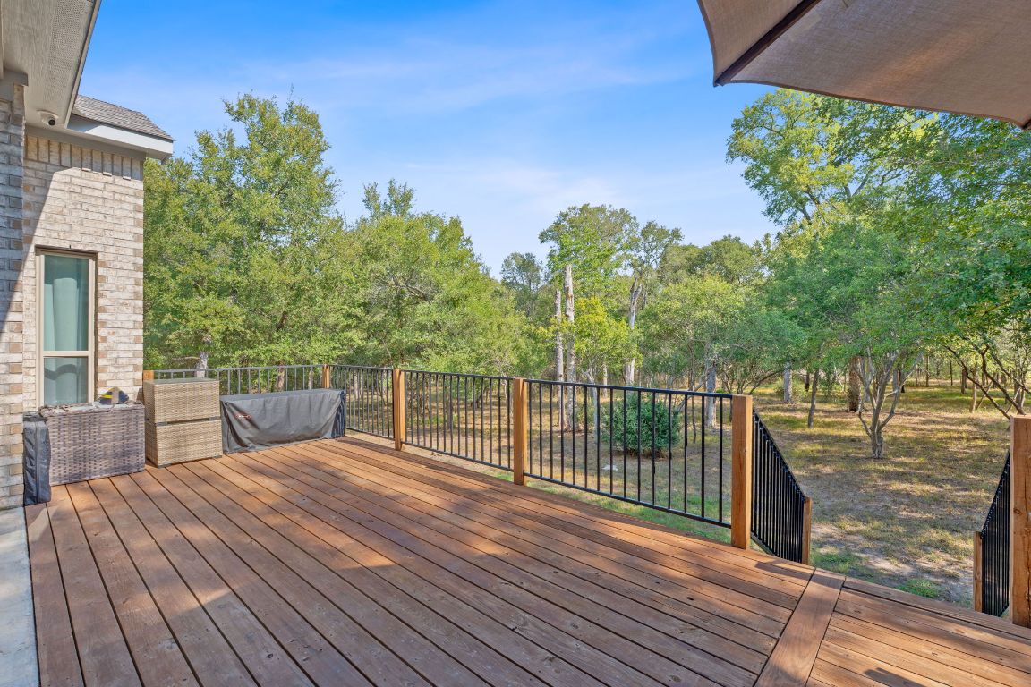 159 Raptor Beak Way Cedar Creek, TX 78612 - Photo 7 of 31 a view of a balcony with wooden floor and fence