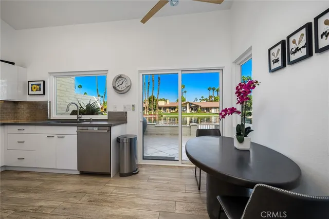 a kitchen with granite countertop a sink and a stove top oven
