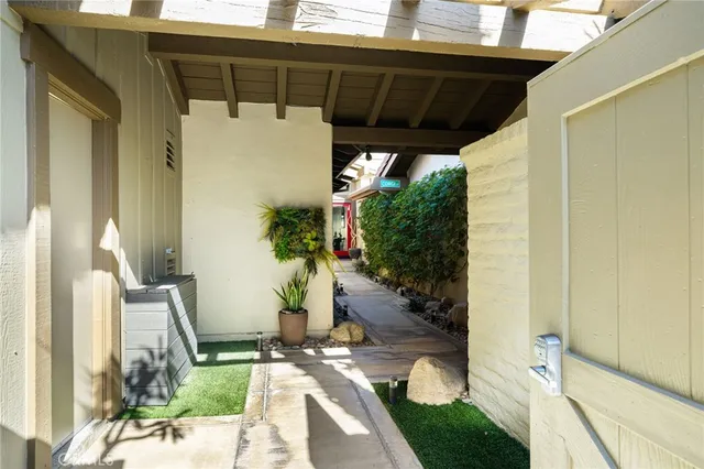 a bedroom with a bed and a potted plant