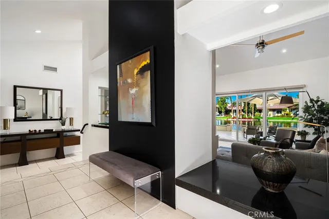 a bedroom with a bed and a flat tv screen on wall