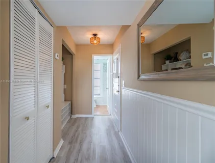a view of hallway with wooden floor