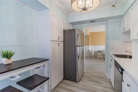 a kitchen with a refrigerator and a sink