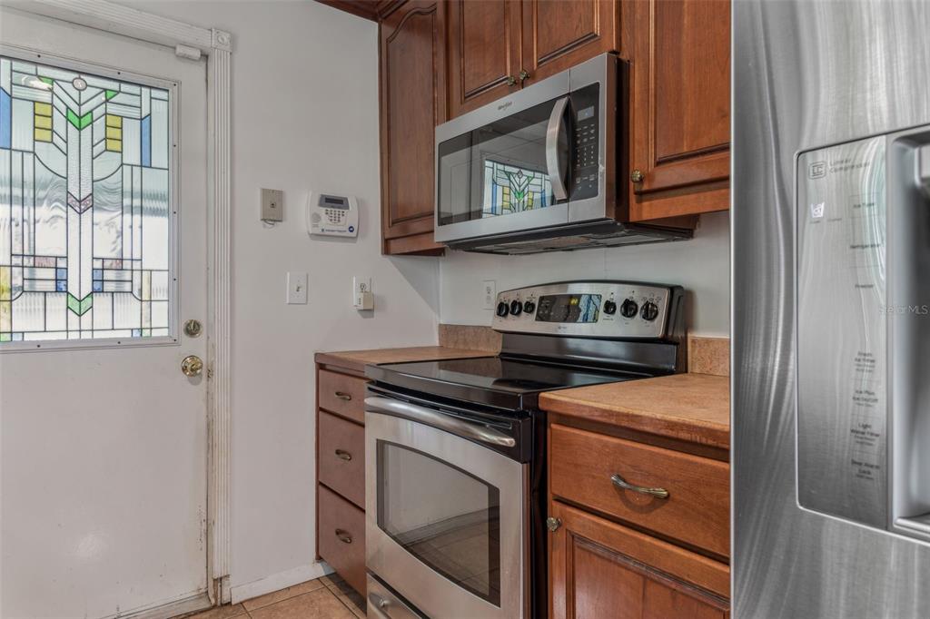 33546 Chancey Road Wesley Chapel, FL 33543 - Photo 8 of 25 a kitchen with stainless steel appliances granite countertop a stove microwave and a refrigerator