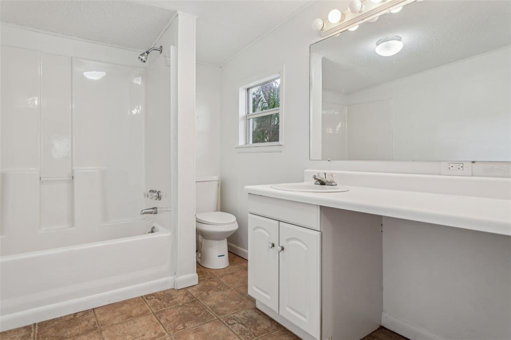 33546 Chancey Road Wesley Chapel, FL 33543 - Photo 10 of 25 a bathroom with a sink a toilet and shower