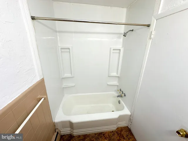 a bathroom with a tub and a shower