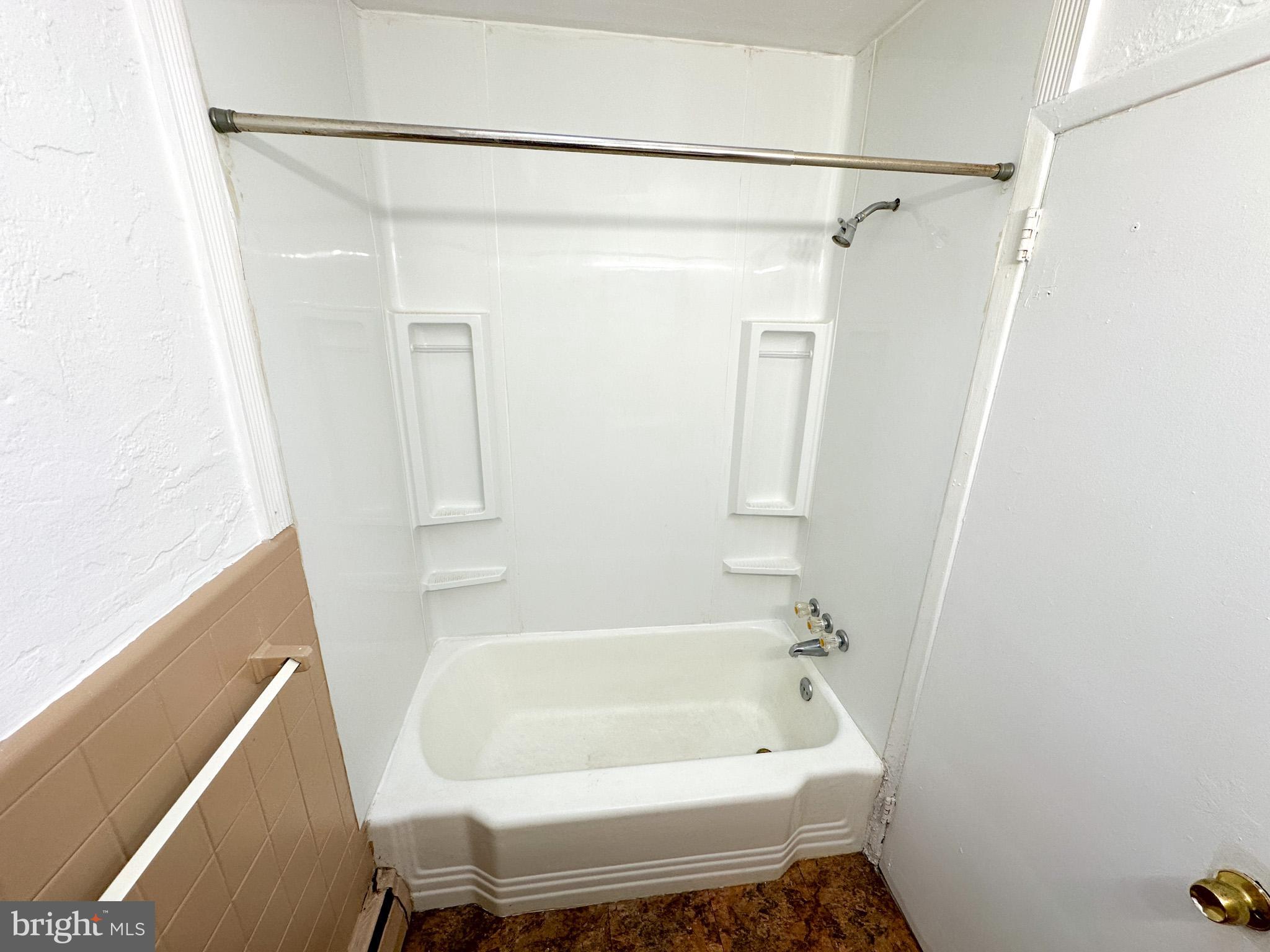 1205-7 Princeton Avenue, Unit C Philadelphia, PA 19111 - Photo 7 of 15 a bathroom with a tub and a shower