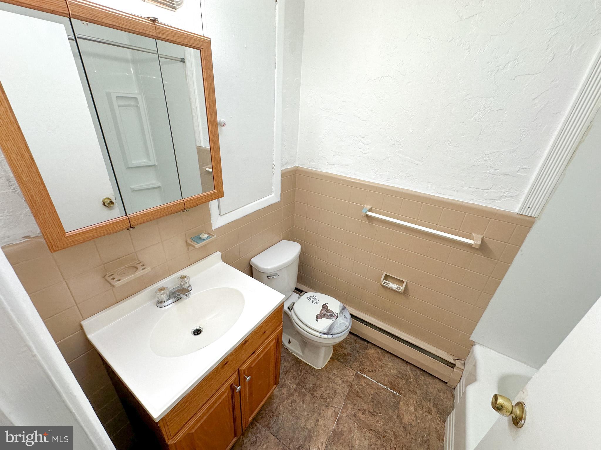 1205-7 Princeton Avenue, Unit C Philadelphia, PA 19111 - Photo 8 of 15 a bathroom with a sink toilet and mirror