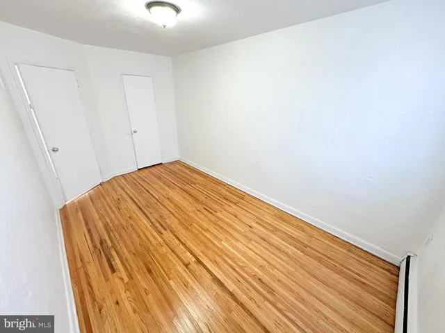 a bedroom with a bed and a rug