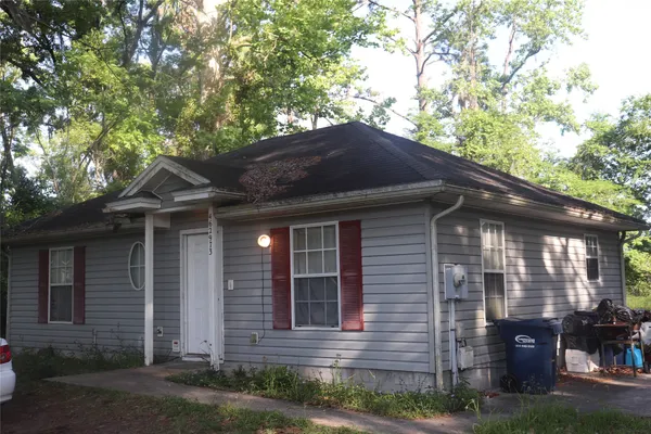 a house that has a tree in front of the house