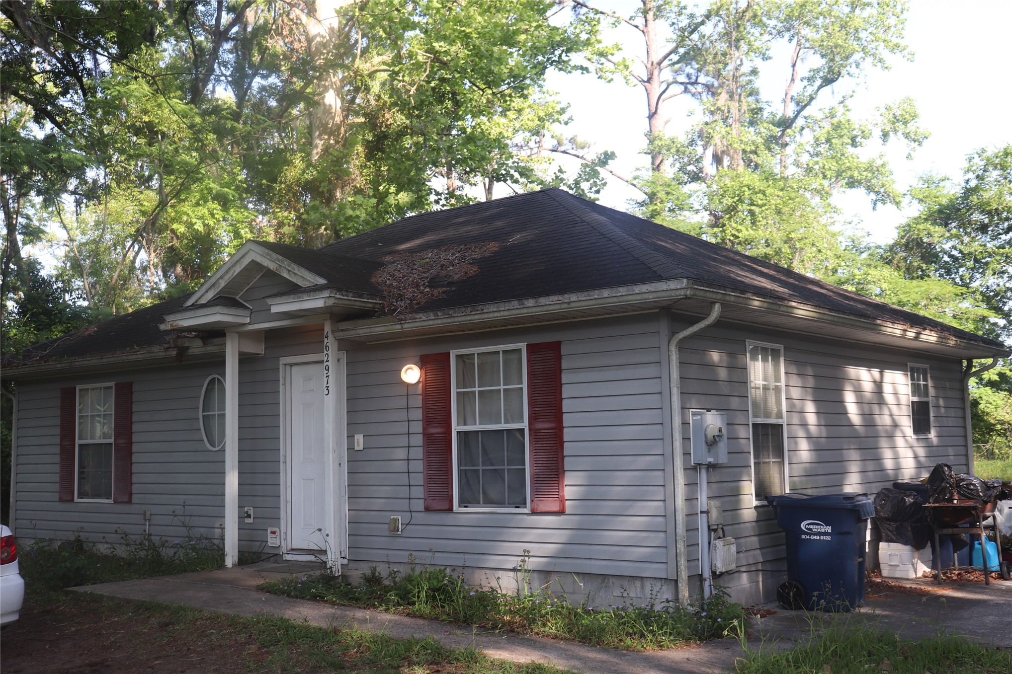 a house that has a tree in front of the house