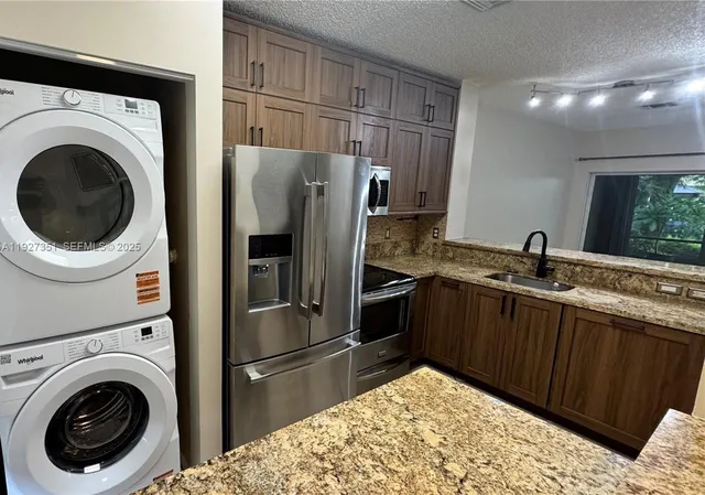 a kitchen with a sink and a refrigerator