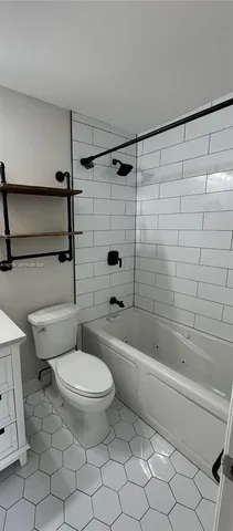 a bathroom with a toilet and a bath tub