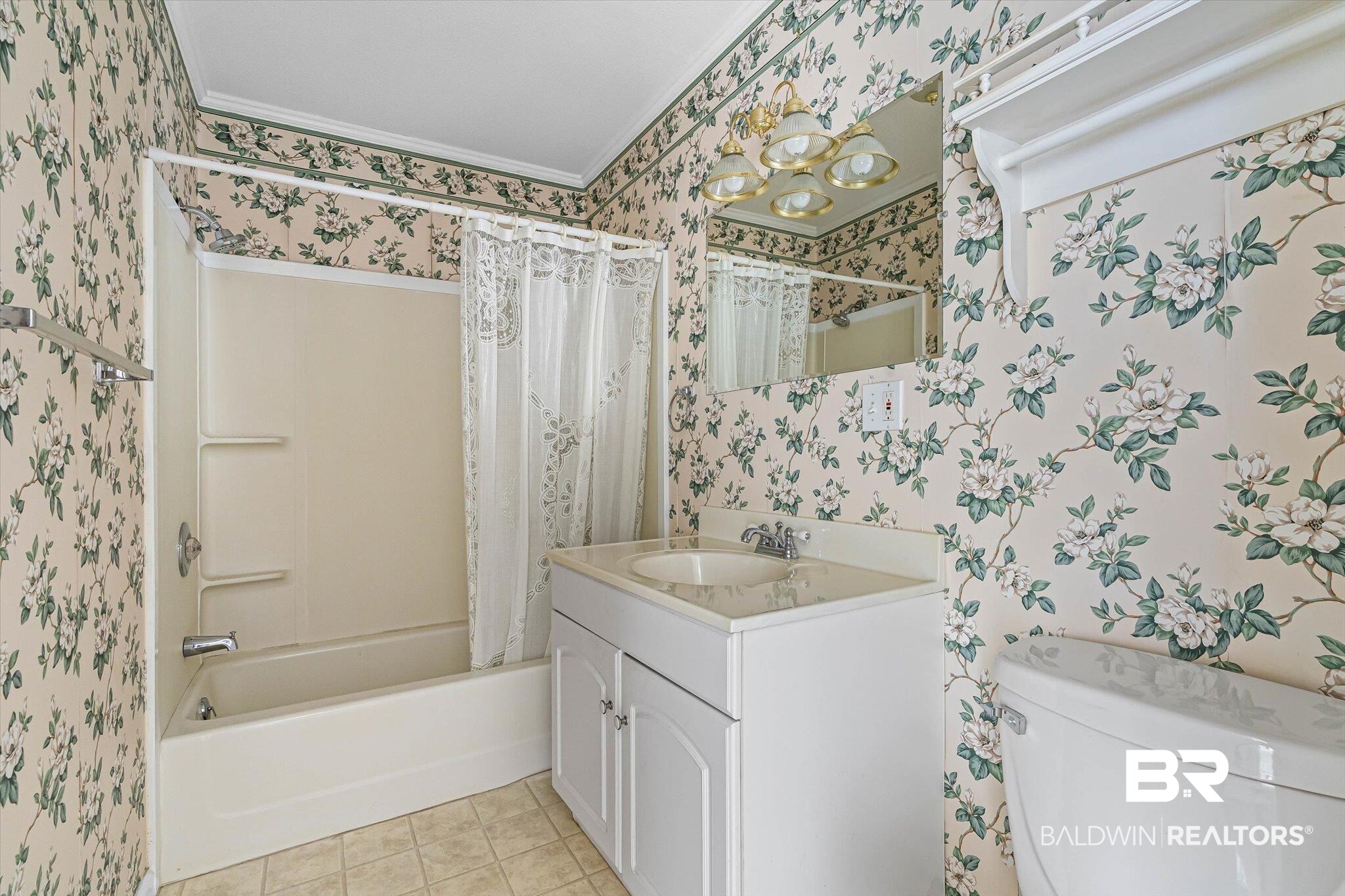 431 Simms Drive Saraland, AL 36571 - Photo 14 of 34 Full bath featuring wallpapered walls, shower / tub combo with curtain, vanity, light tile patterned flooring, and ornamental molding