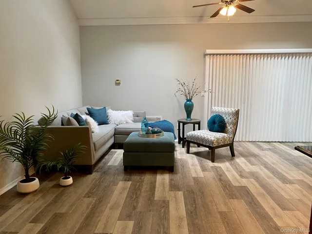 a living room with furniture and a lamp
