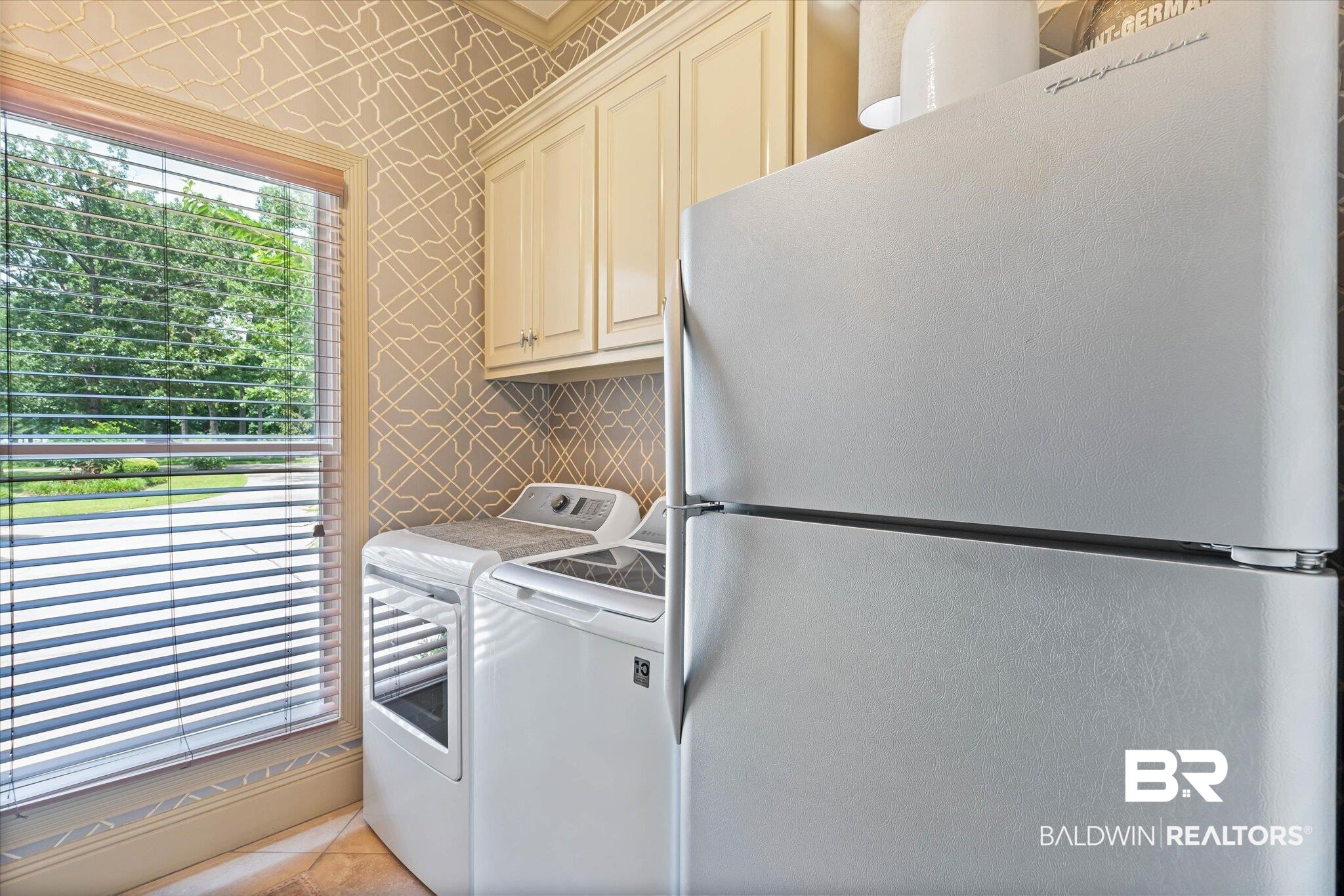 2905 Riverview Pointe Drive South Theodore, AL 36582 - Photo 17 of 44 Laundry room featuring washer and dryer and tile patterned flooring