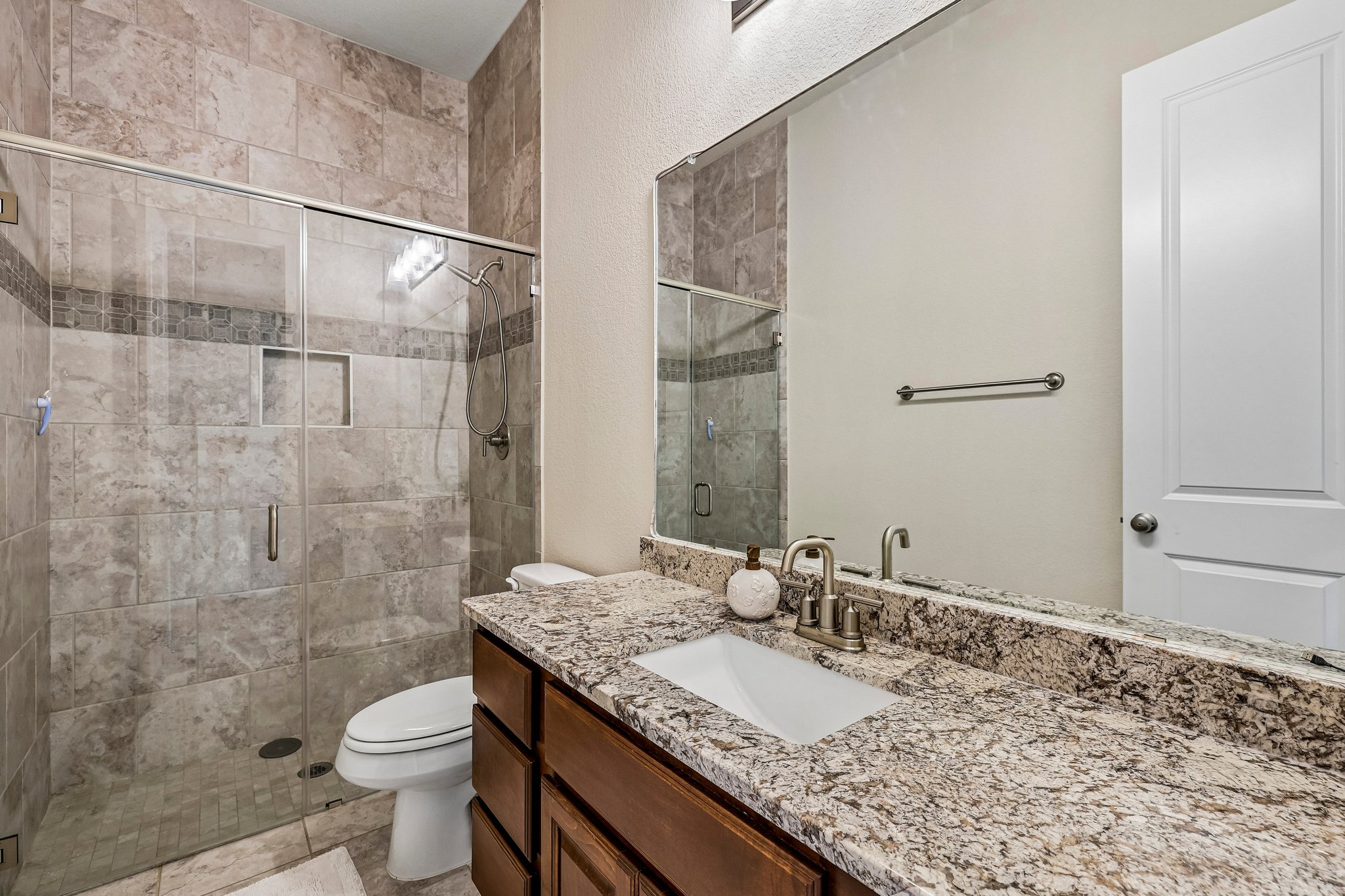 1705 Parten Rnch Parkway Austin, TX 78737 - Photo 16 of 39 A well-appointed bathroom offers a spacious walk-in shower and an elegant granite vanity.