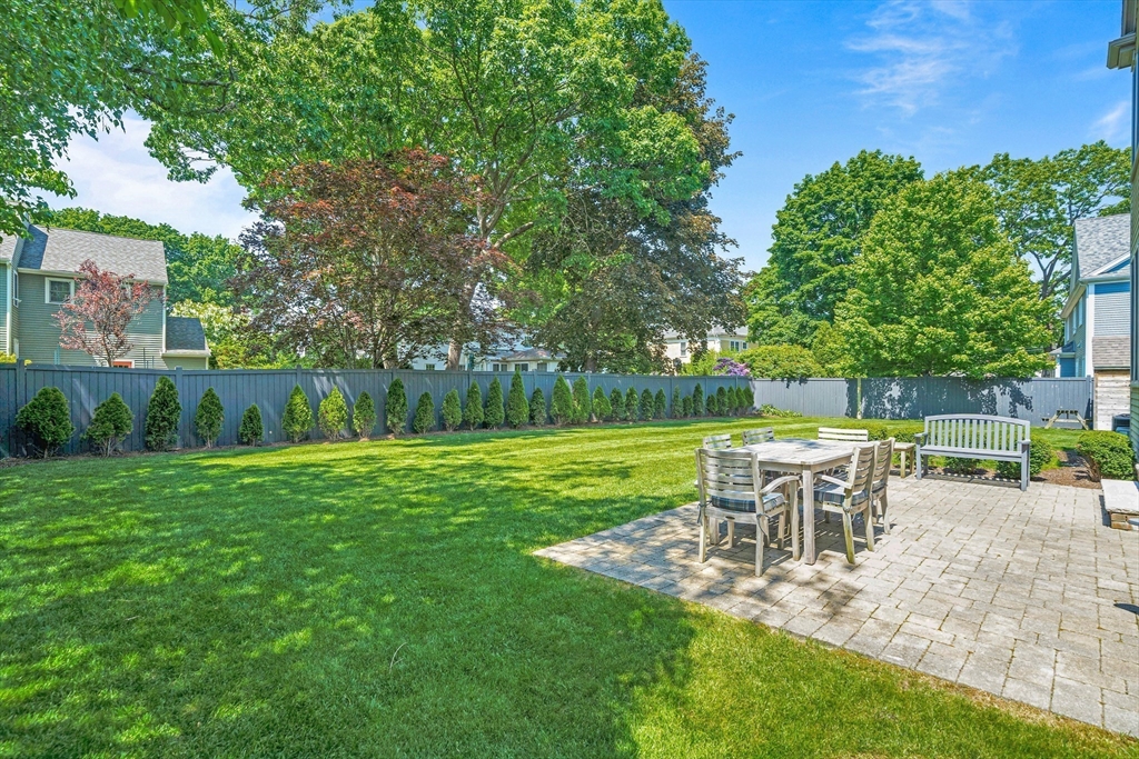 9 Patton Road Wellesley, MA 02482 - Photo 31 of 34 a view of a backyard with table and chairs potted plants and large tree