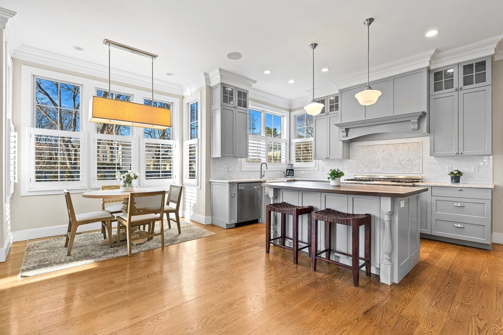 9 Patton Road Wellesley, MA 02482 - Photo 4 of 34 a large kitchen with granite countertop a stove a sink a dining table and chairs