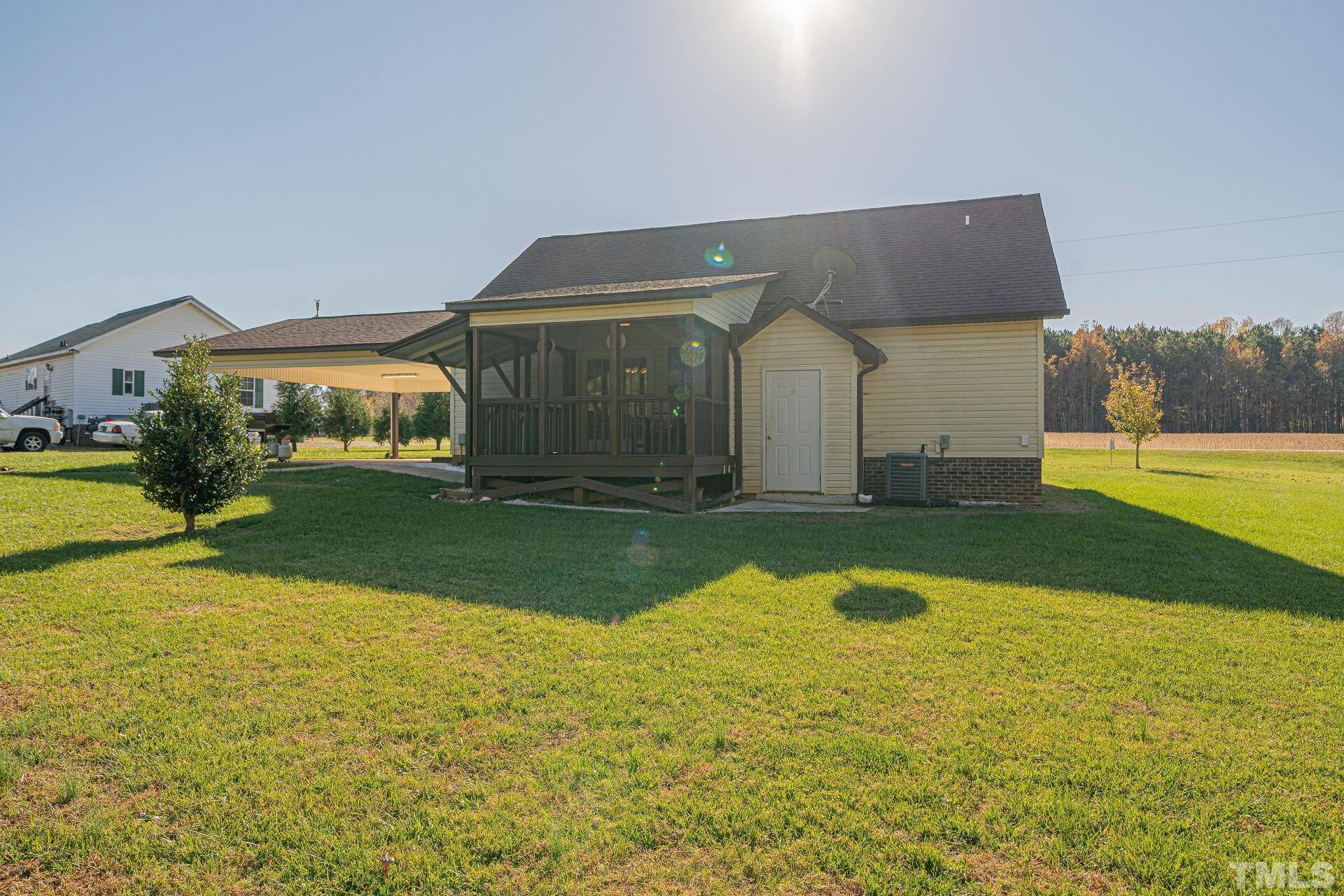 7039 Stokes Road Middlesex, NC 27557 - Photo 22 of 25 a view of swimming pool with lawn chairs and large trees