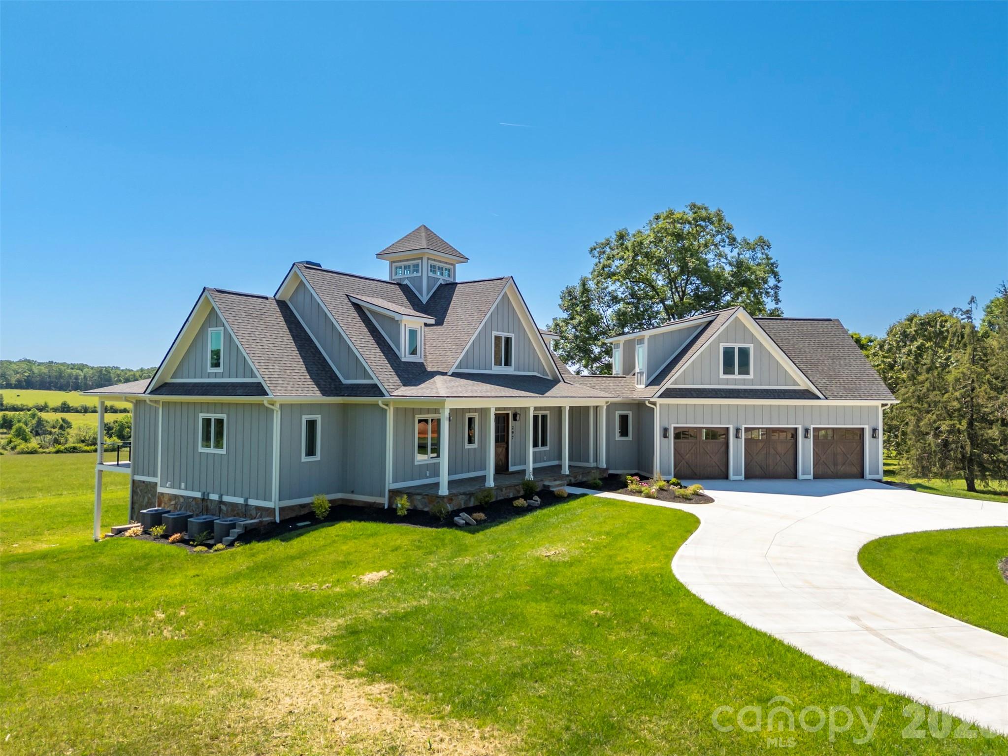 297 Mountain Meadows Lane, Unit 7 Tryon, NC 28782 - Photo 44 of 47 a view of a house with a big yard and large trees