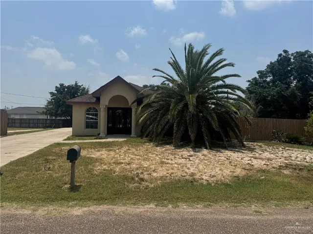 an empty room with windows and ceiling fan