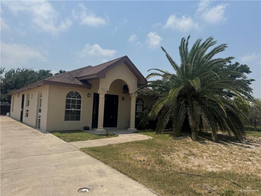 310 Adams Avenue Alton, TX 78573 - Photo 4 of 13 View of front of house with stucco siding and concrete driveway