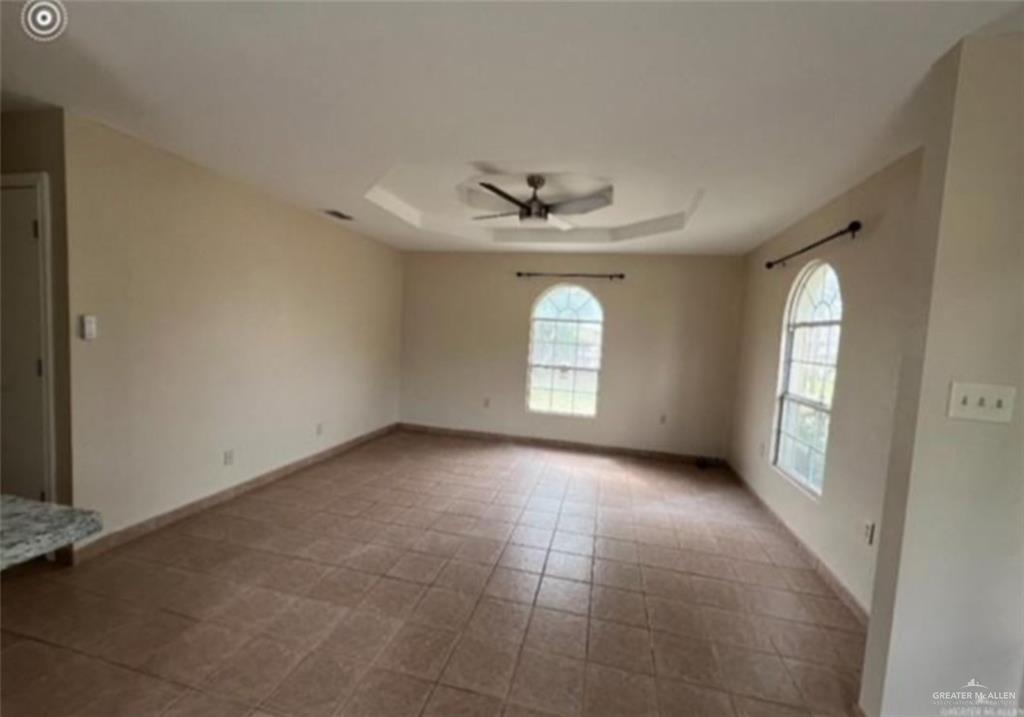310 Adams Avenue Alton, TX 78573 - Photo 5 of 13 an empty room with windows and ceiling fan