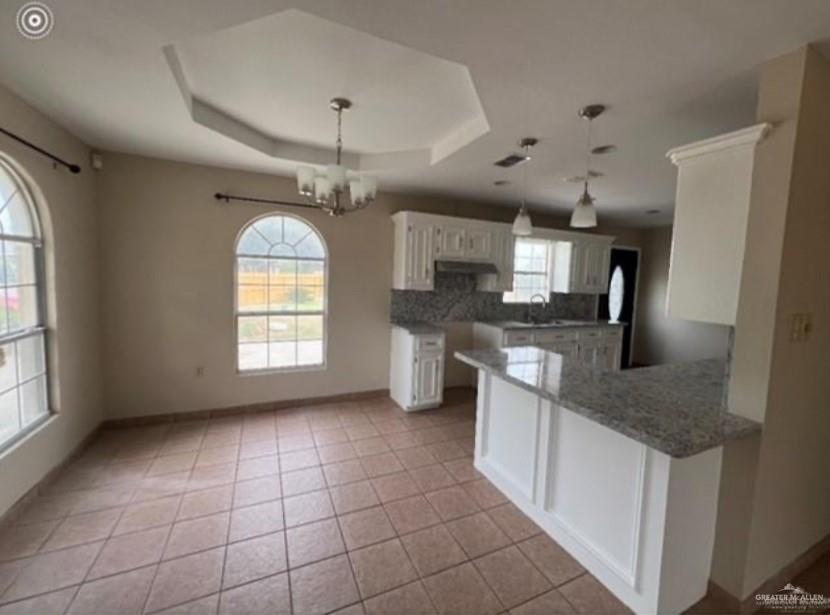 310 Adams Avenue Alton, TX 78573 - Photo 6 of 13 a kitchen with stainless steel appliances granite countertop a sink a stove a refrigerator and cabinets