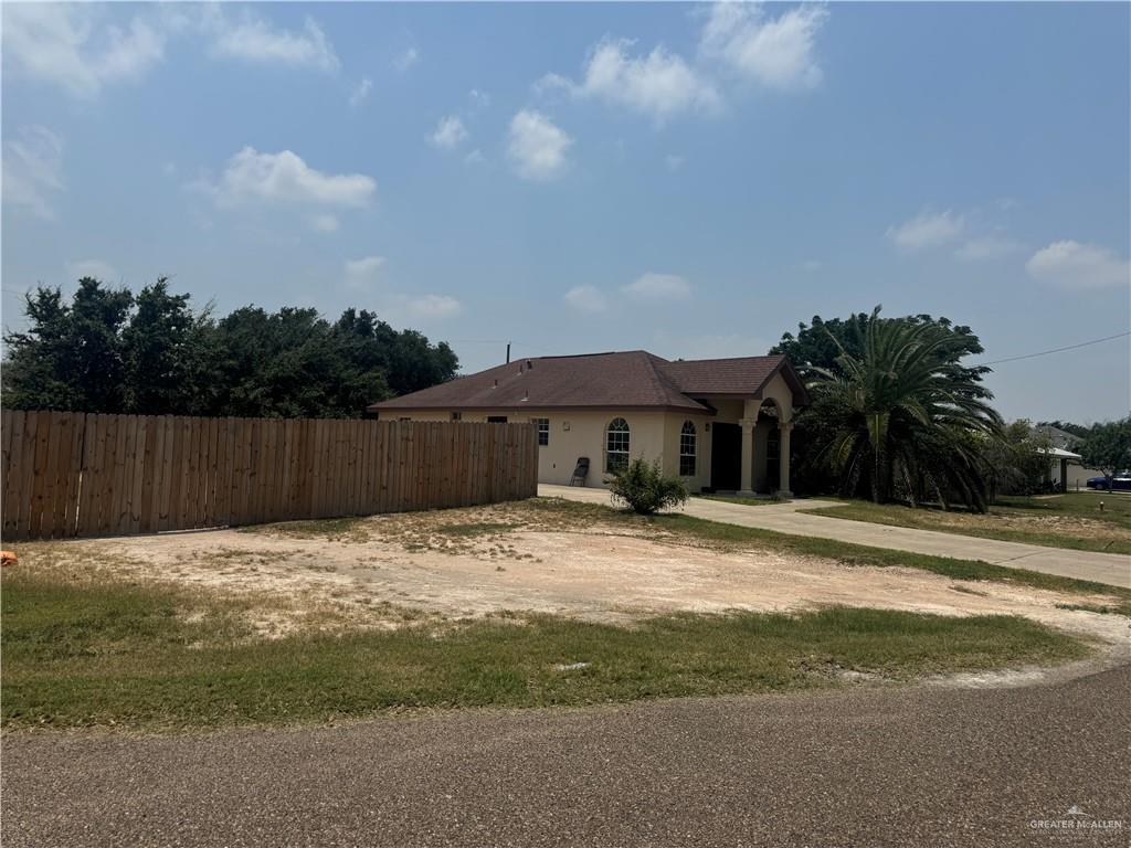 310 Adams Avenue Alton, TX 78573 - Photo 8 of 13 View of side of home with fence and driveway