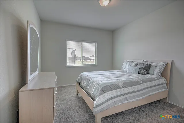 a bedroom with bed and window