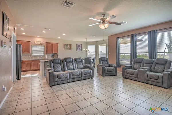 a living room with furniture and a chandelier