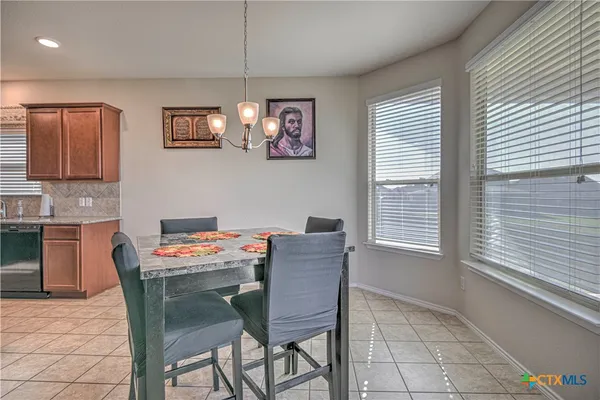 a dining room with furniture and window