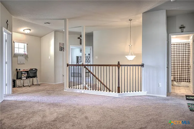 a view of a hallway with entryway door