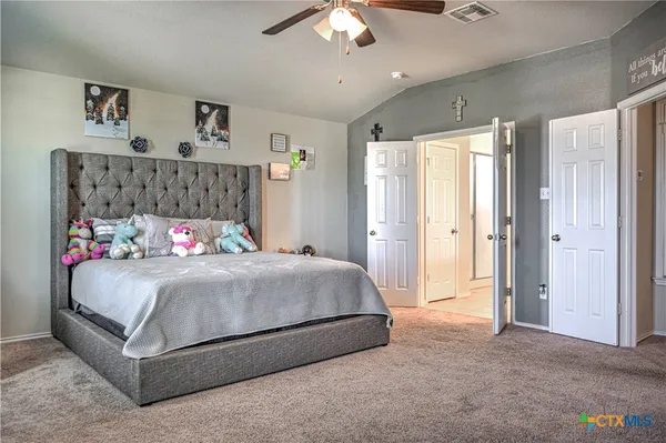 a bedroom with a bed and a chandelier