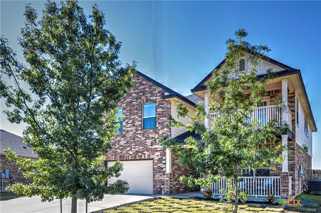 a view of a house with a tree