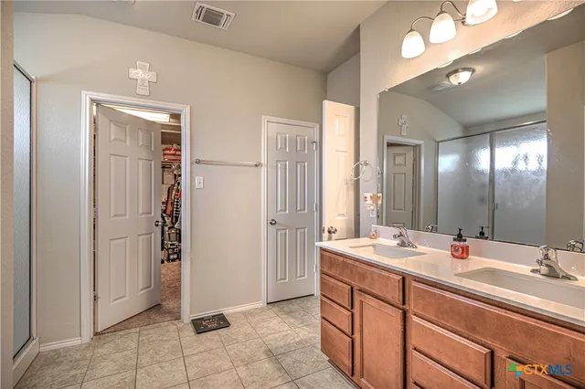 a bathroom with a sink double vanity and a mirror