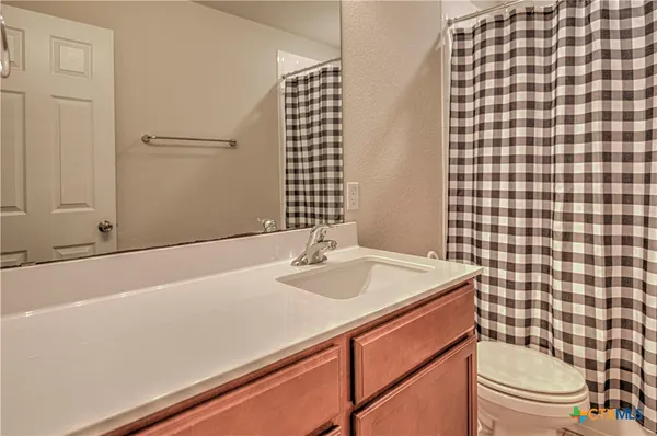 a bathroom with a sink a toilet and a mirror