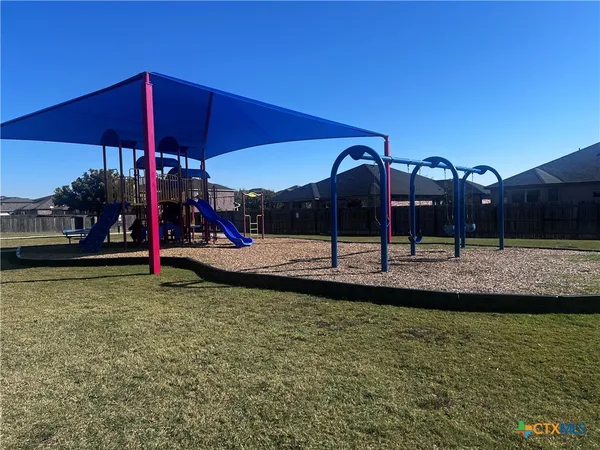 a view of a house with a yard and sitting area
