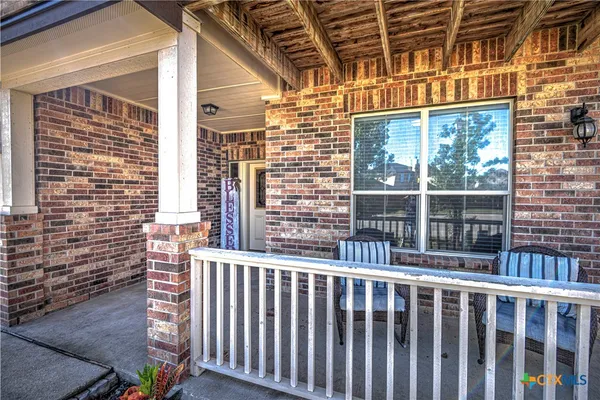 a view of a brick house with a large windows
