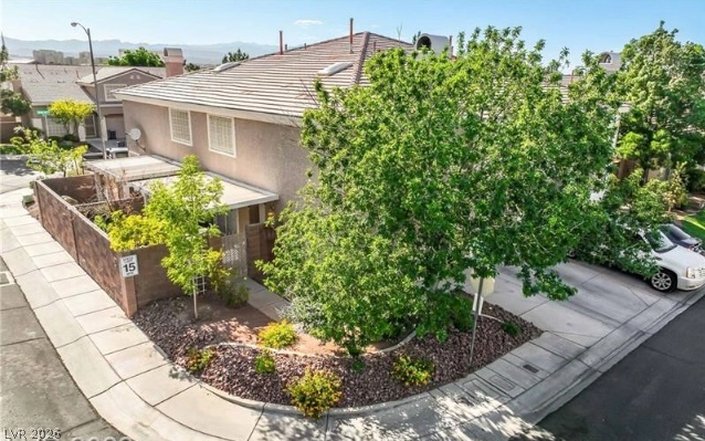 10247 Rising Tree Street Las Vegas, NV 89183 - Photo 2 of 7 Mature trees and landscaping create an inviting approach to this charming residence with ample parking.