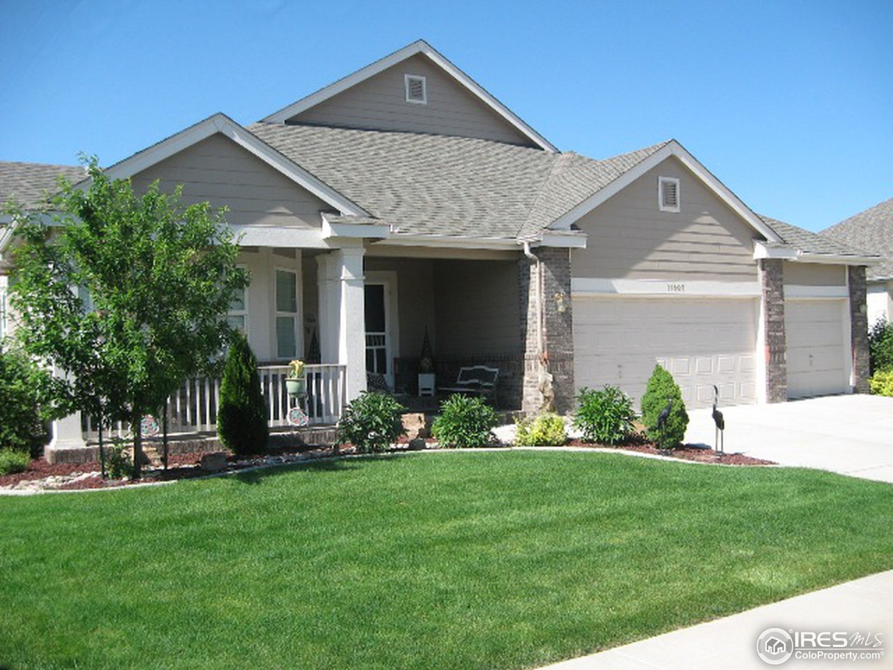 11805 North Beasly Road Longmont, CO 80504 - Photo 3 of 20 a front view of a house with garden