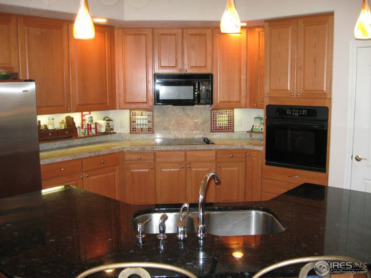 11805 North Beasly Road Longmont, CO 80504 - Photo 4 of 20 a kitchen with a sink a stove and cabinets