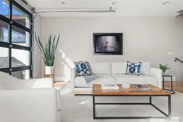 a living room with furniture wooden floor and a flat screen tv