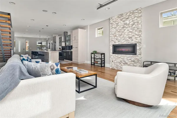 a living room with furniture and a wooden floor