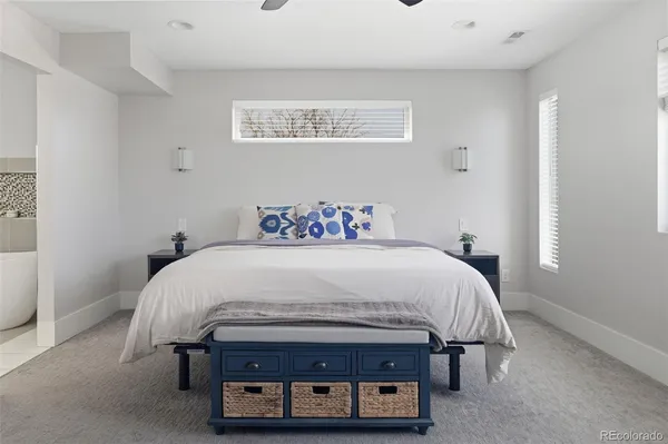 a spacious bedroom with a bed and a chandelier