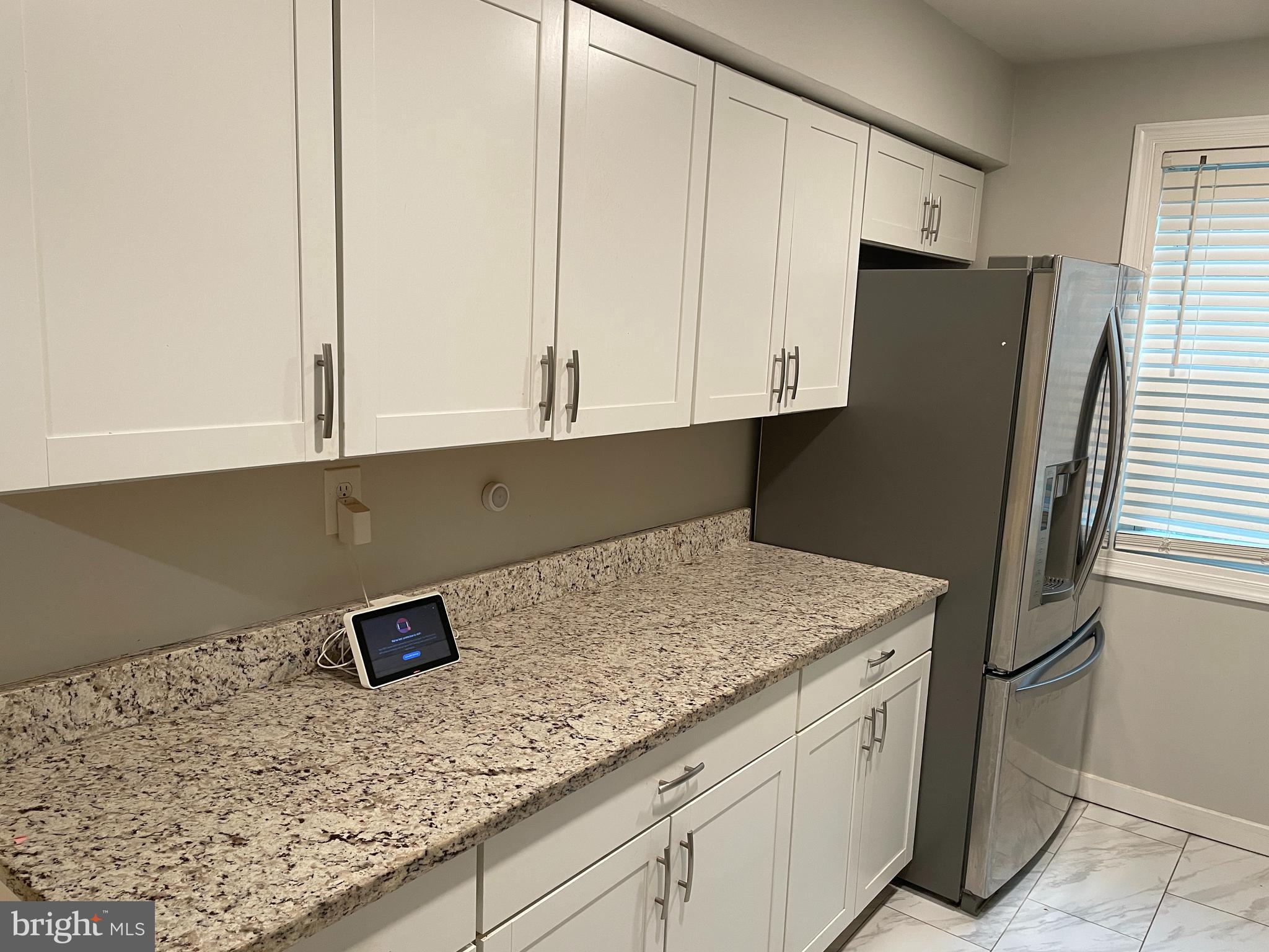 2307 Wyngate Road Suitland, MD 20746 - Photo 6 of 22 a kitchen with stainless steel appliances granite countertop white cabinets and a refrigerator