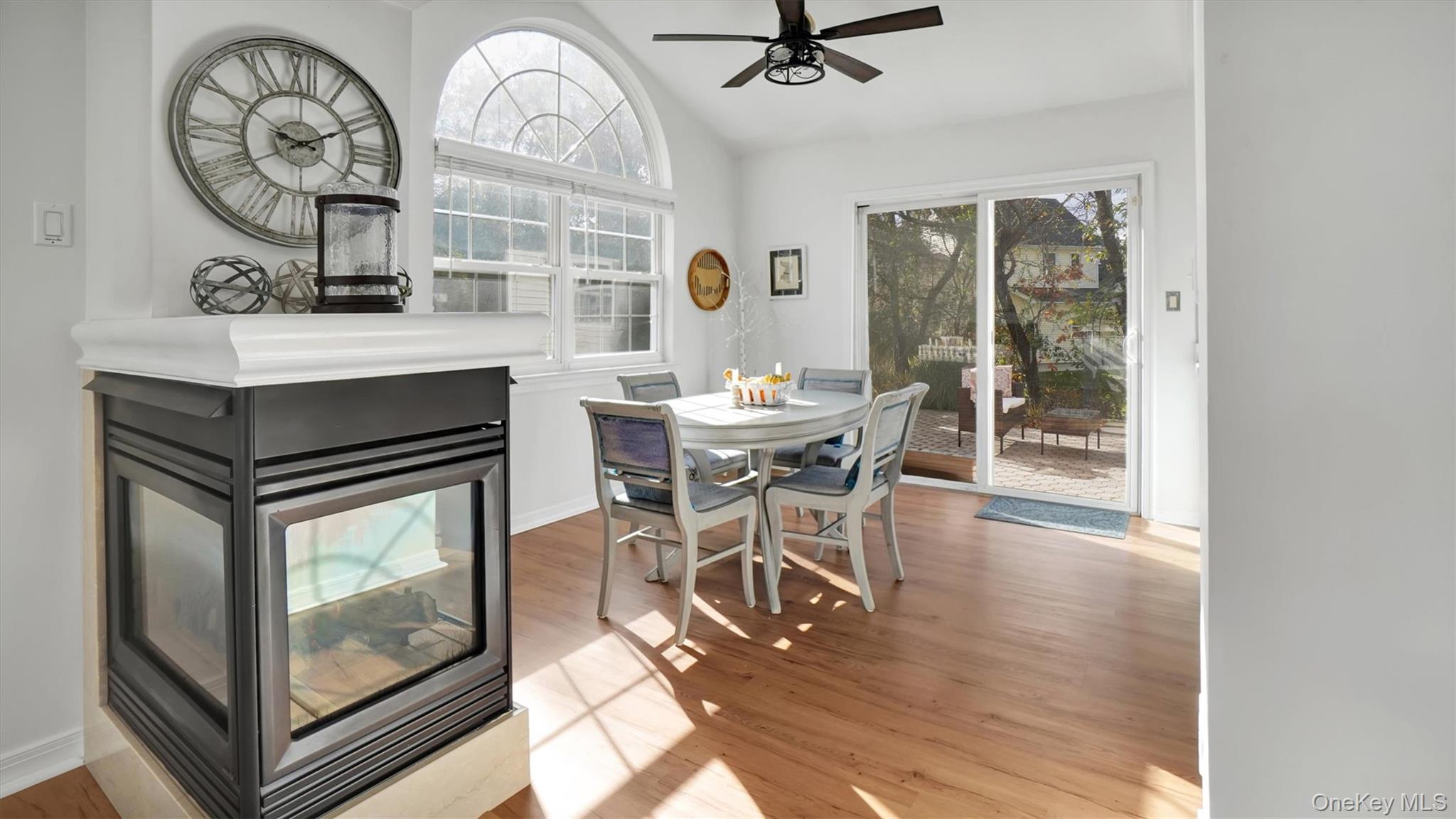 601 Pebble Beach Path Riverhead, NY 11901 - Photo 6 of 20 a dining room with wooden floor a glass table and chairs