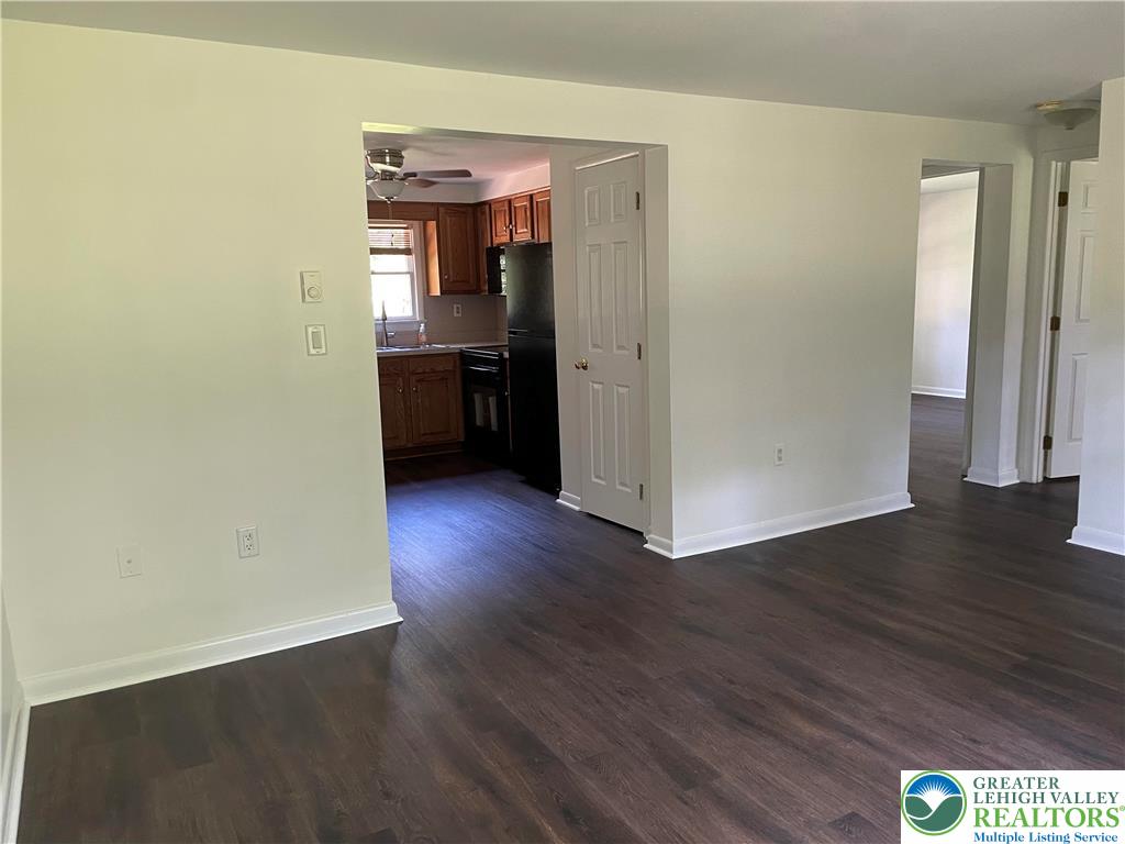 849 Weir Lake Road Kunkletown, PA 18058 - Photo 17 of 44 an empty room with wooden floor and kitchen